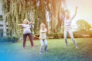 Female members of family playing with hula hoop